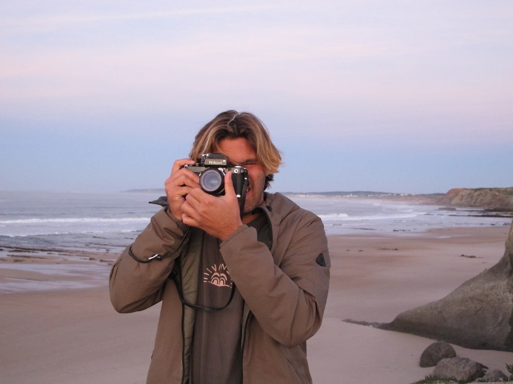 Maor Cohen Falah taking a photo on the beach